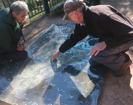 men looking at map on ground