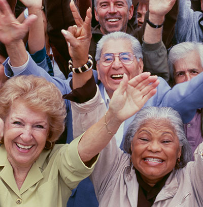 seniors group with hands in the air