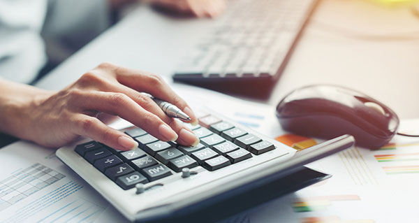 Close up hand of business woman accountant or banker making calculations