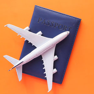 plane on passport on orange background