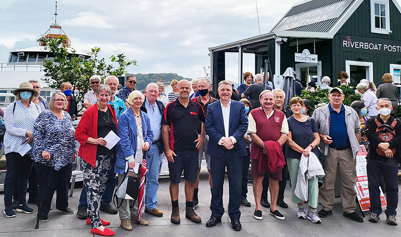 Group in front of boat and booth