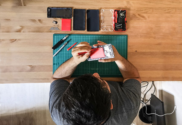 man soldering electronic item